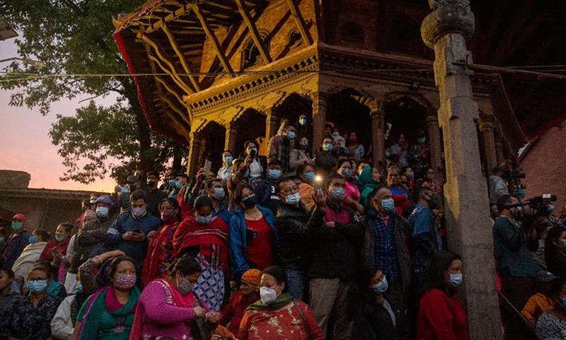 People take part in the Seto Machhendranath chariot procession in Kathmandu, Nepal, April 21, 2021. Seto Machhendranath is known as the god of rain and both Hindus and Buddhists worship Machhendranath for good rain to prevent drought during the rice harvest season. Photo: Xinhua