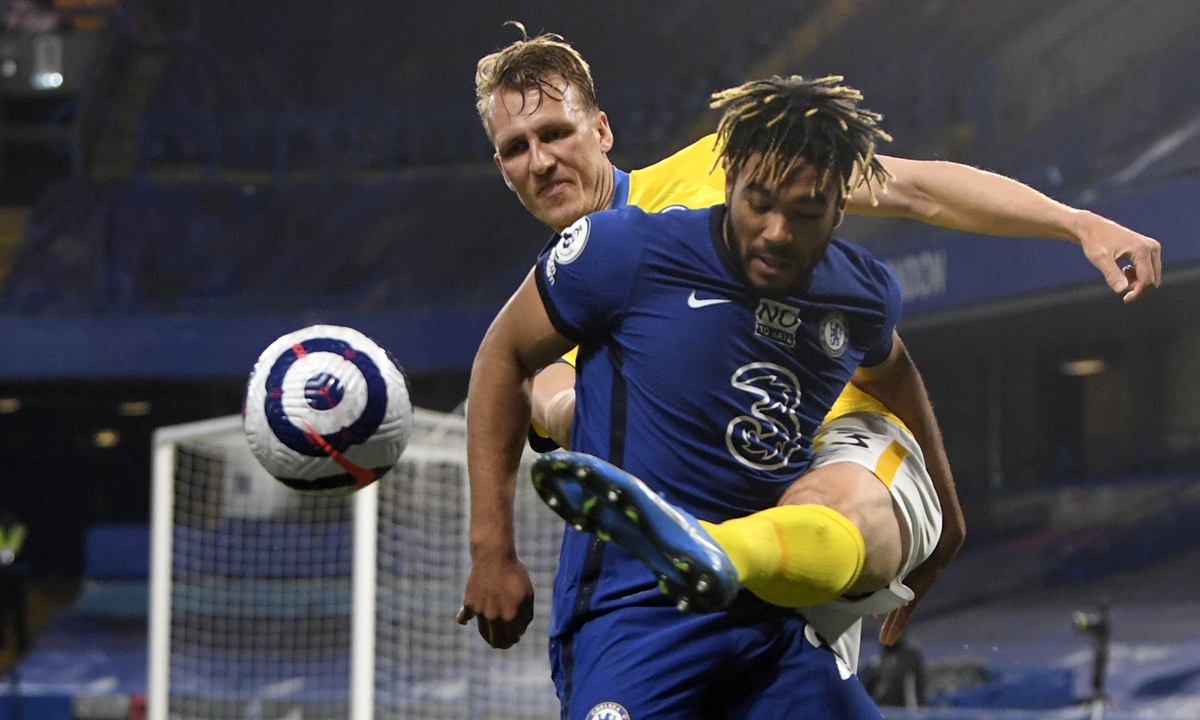 Chelsea's Reece James (front) duels for the ball with Brighton's Dan Burn on Tuesday in London, England. Photo: VCG