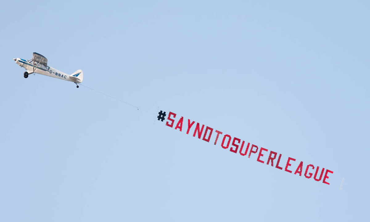 Fans fly a plane banner which reads 