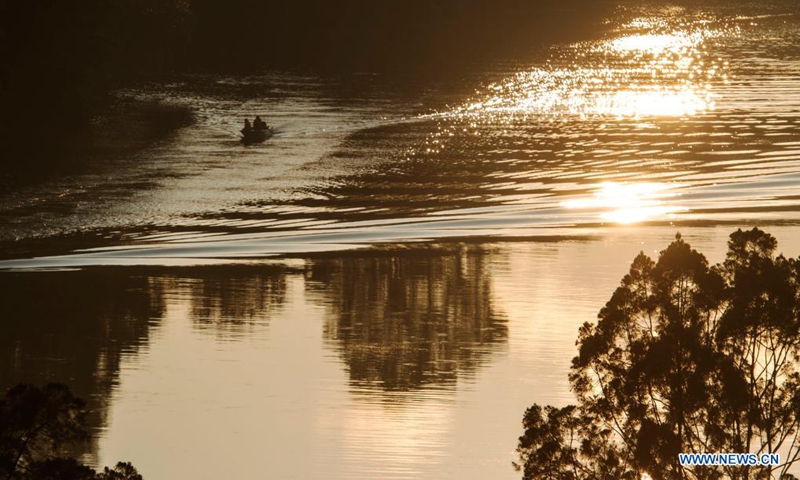 Workers ride on a boat in Singapore's Central Catchment Nature Reserve on April 21, 2021.(Photo: Xinhua)