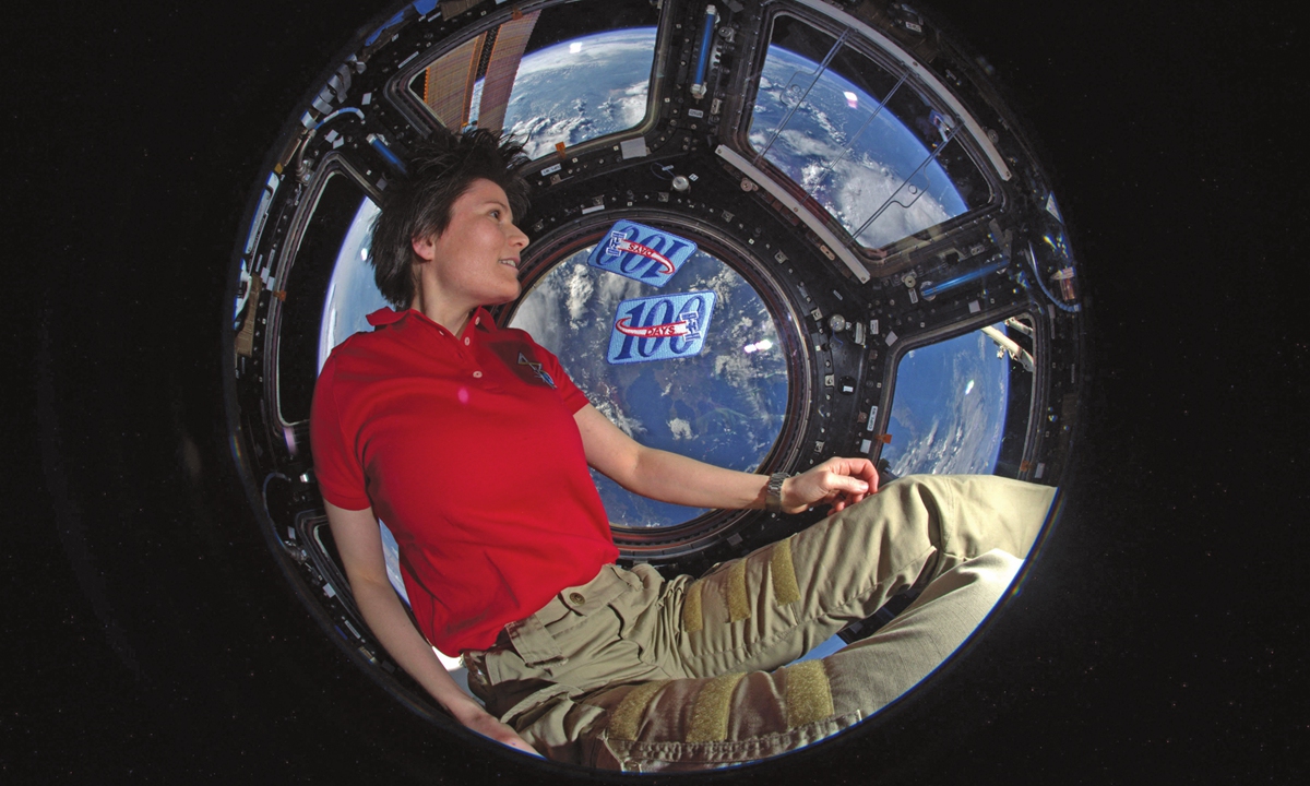 Italian ESA astronaut Samantha Cristoforetti poses in the Cupola module of the International Space Station to mark her 200th day in space in 2015. 
Photo: VCG