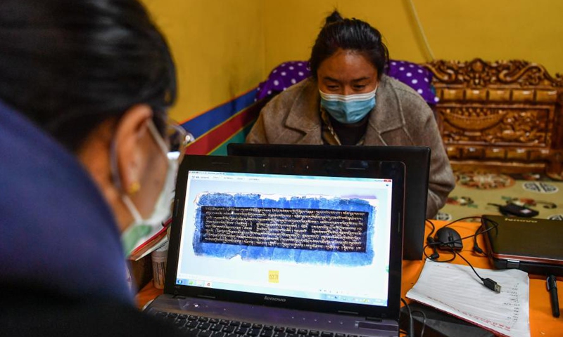 Staff members with the regional ancient book protection center upload digital scans of rare ancient books to an online platform under the official website of the Tibet Library in Lhasa, southwest China's Tibet Autonomous Region, April 20, 2021.Photo:Xinhua
