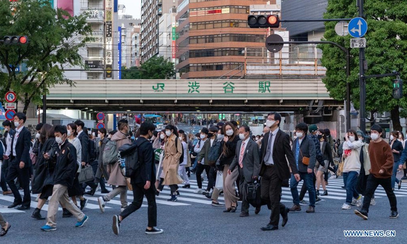 Pedestrians wearing protective face masks walk across a busy intersection at Shibuya in Tokyo, Japan on April 23, 2021. Japan's Prime Minister Yoshihide Suga on Friday declared a third state of emergency over COVID-19 in Tokyo, Osaka, Kyoto and Hyogo. The state of emergency will come into effect from Sunday to May 11.Photo:Xinhua