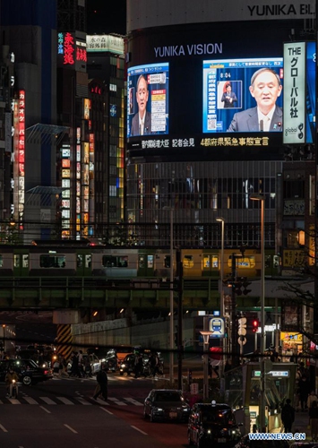 Japan's Prime Minister Yoshihide Suga is shown on outdoor screens during a press conference as he declares a state of emergency over COVID-19 in Tokyo, Japan on April 23, 2021. Yoshihide Suga on Friday declared a third state of emergency over COVID-19 in Tokyo, Osaka, Kyoto and Hyogo. The state of emergency will come into effect from Sunday to May 11.Photo:Xinhua