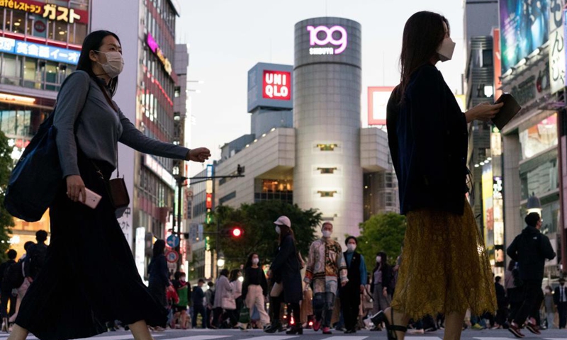 Pedestrians wearing protective face masks walk across a busy intersection at Shibuya in Tokyo, Japan on April 23, 2021. Japan's Prime Minister Yoshihide Suga on Friday declared a third state of emergency over COVID-19 in Tokyo, Osaka, Kyoto and Hyogo. The state of emergency will come into effect from Sunday to May 11.Photo:Xinhua