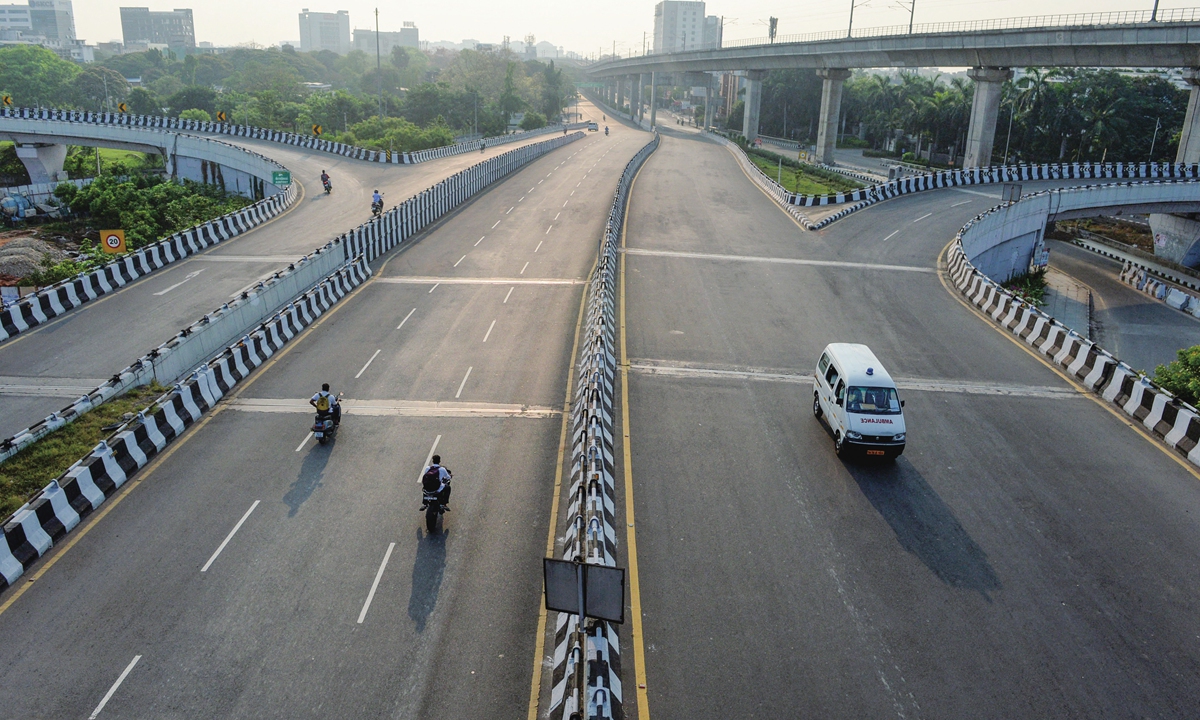 A partially deserted road is seen during the Sunday lockdown imposed as a preventive measure against the spread of the COVID-19 in Chennai, India, on Sunday. Photo: AFP