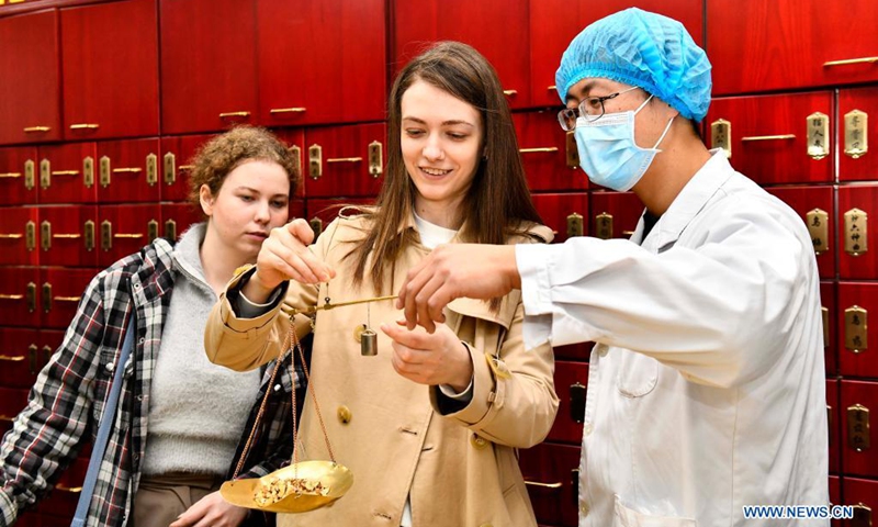 Students from China University of Petroleum experience traditional Chinese medicine (TCM) culture at the TCM cultural base in Traditional Chinese medical hospital of Huangdao District, Qingdao, east China's Shandong Province, April 23, 2021. (Photo: Xinhua)