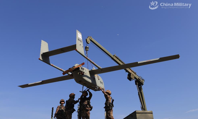 Members assigned to a female UAV detachment under the PLA 72nd Group Army hoist the drone during an actual combat training exercise in early April, 2021. The training involved such items as emergency flight preparation, reconnaissance and confrontation of the drones under high altitude and adverse weather conditions in strange areas. (eng.chinamil.com.cn/Photo by Huang Baochuan and Zhang Linyu)