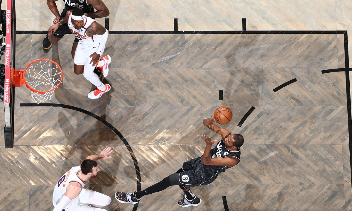 Kevin Durant of the Brooklyn Nets shoots the ball against the Phoenix Suns on Sunday in New York City. Photo: AFP