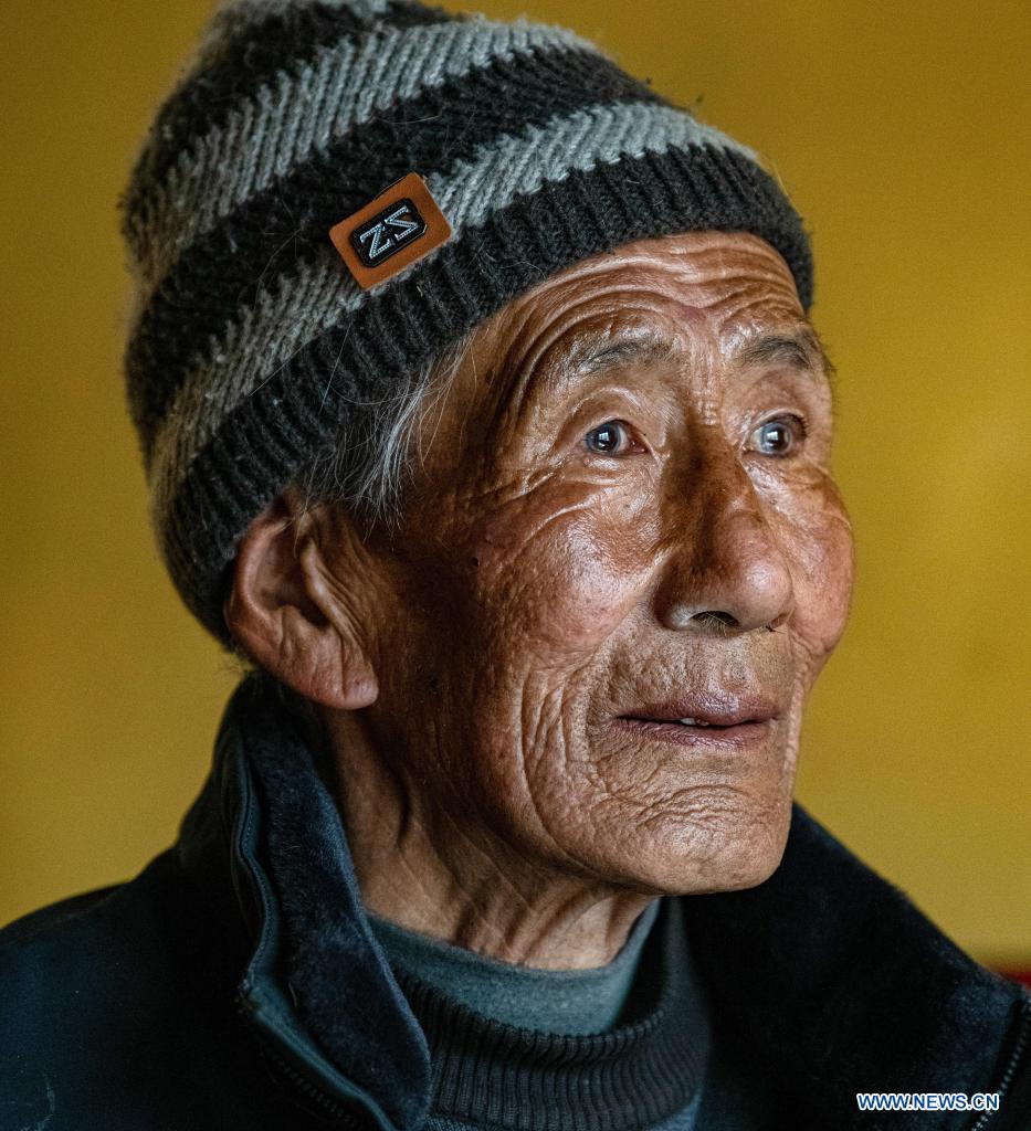 Tsering poses for a portrait at home in Nyinzhung Township of Damxung County, Lhasa City of southwest China's Tibet Autonomous Region, April 16, 2021. Tsering, born in 1944 as a herdsman in Nyinzhung Township, recalls the old times in Tibet when heavy and various duties in pasture area squeezed the life of local people.(Photo:Xinhua)