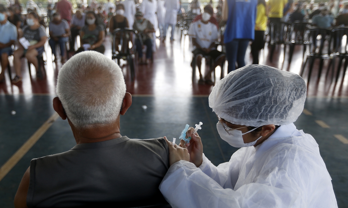 A man receives China-made COVID-19 vaccine in Brasilia, Brazil. Photo: Xinhua