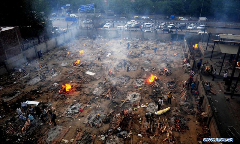 Burning funeral pyres are seen during a mass cremation for those who died from the COVID-19 at a crematorium in Delhi, India, on April 26, 2021.(Photo: Xinhua)