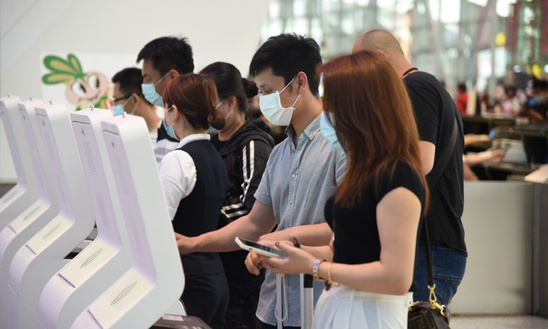 Passengers operate automatic check-in machines at Baiyun International Airport in Guangzhou, south China's Guangdong Province, April 26, 2021.(Photo: Xinhua)