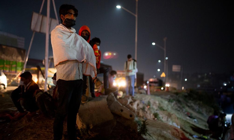 People wait for the long route bus to go back to their village prior to lockdown imposed to curb the COVID-19 infections in Kathmandu, Nepal, April 28, 2021.Photo:Xinhua