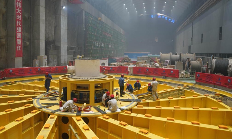 Workers are busy at the construction site of the Baihetan hydropower station in southwest China, April 27, 2021.Photo:Xinhua