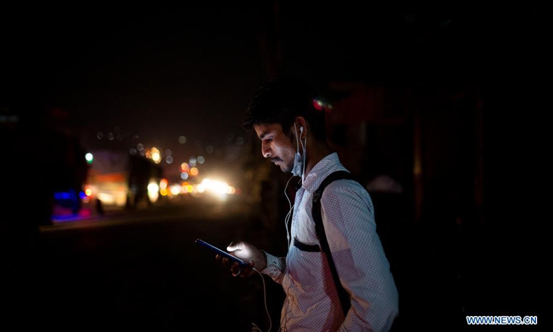 A man waits for the long route bus to go back to his village prior to lockdown imposed to curb the COVID-19 infections in Kathmandu, Nepal, April 28, 2021.Photo:Xinhua