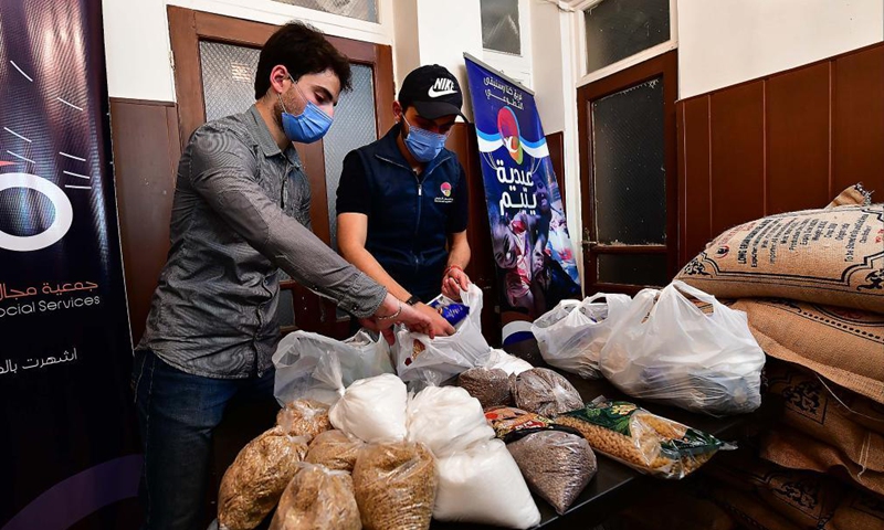 Volunteers prepare charity food parcels during the holy month of Ramadan in Damascus, Syria, on April 20, 2021. As Syria is passing through a tough economic crisis, some charity kitchens started working during the holy month of Ramadan to help people save money by offering free meals and food parcels.Photo:Xinhua