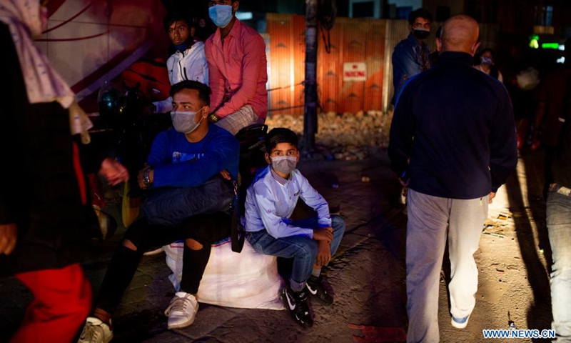 People wait for the long route bus to go back to their village prior to lockdown imposed to curb the COVID-19 infections in Kathmandu, Nepal, April 28, 2021.Photo:Xinhua