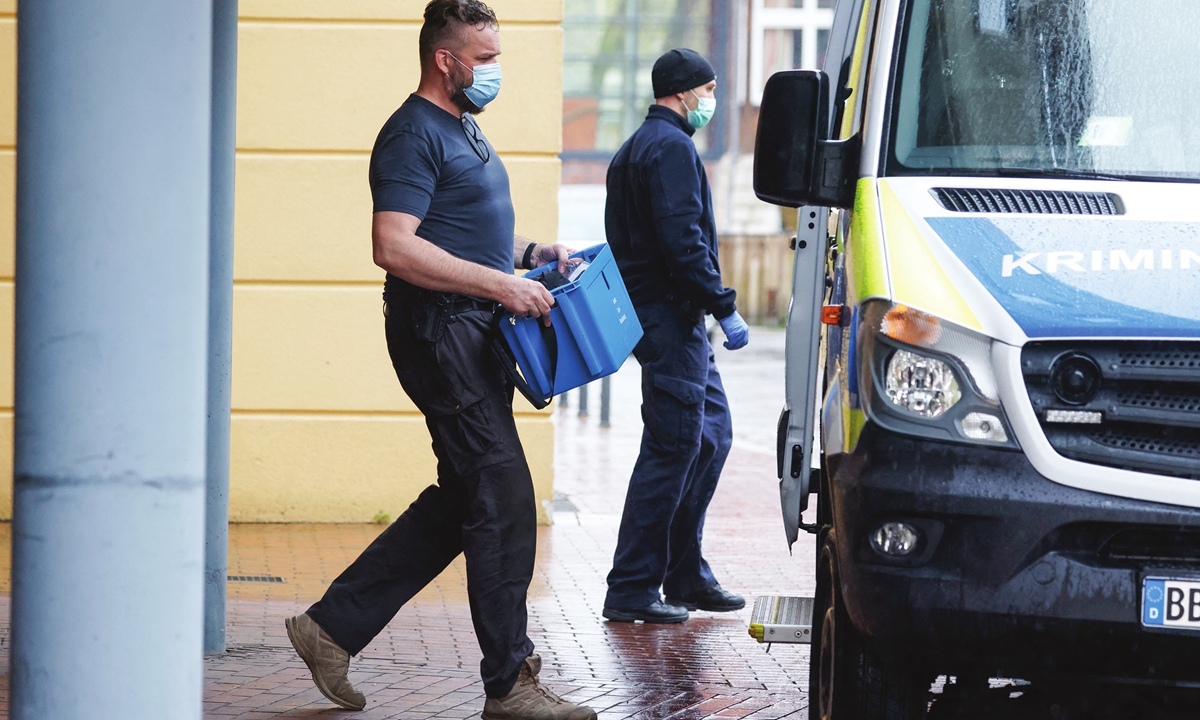 A policeman carries evidence out of the Oberlin care Clinic in the eastern city of Potsdam, Germany, on Thursday, where four people have been killed and one person seriously wounded in an attack on late Wednesday. A 51-year-old employee has been arrested 