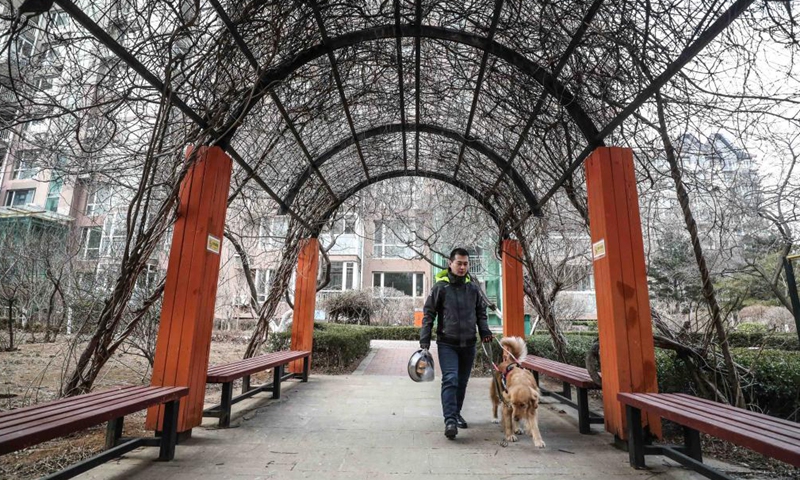 Visually impaired man Wen Shipeng walks with his guide dog in Dalian, northeast China's Liaoning Province, Jan. 13, 2020.Photo:Xinhua