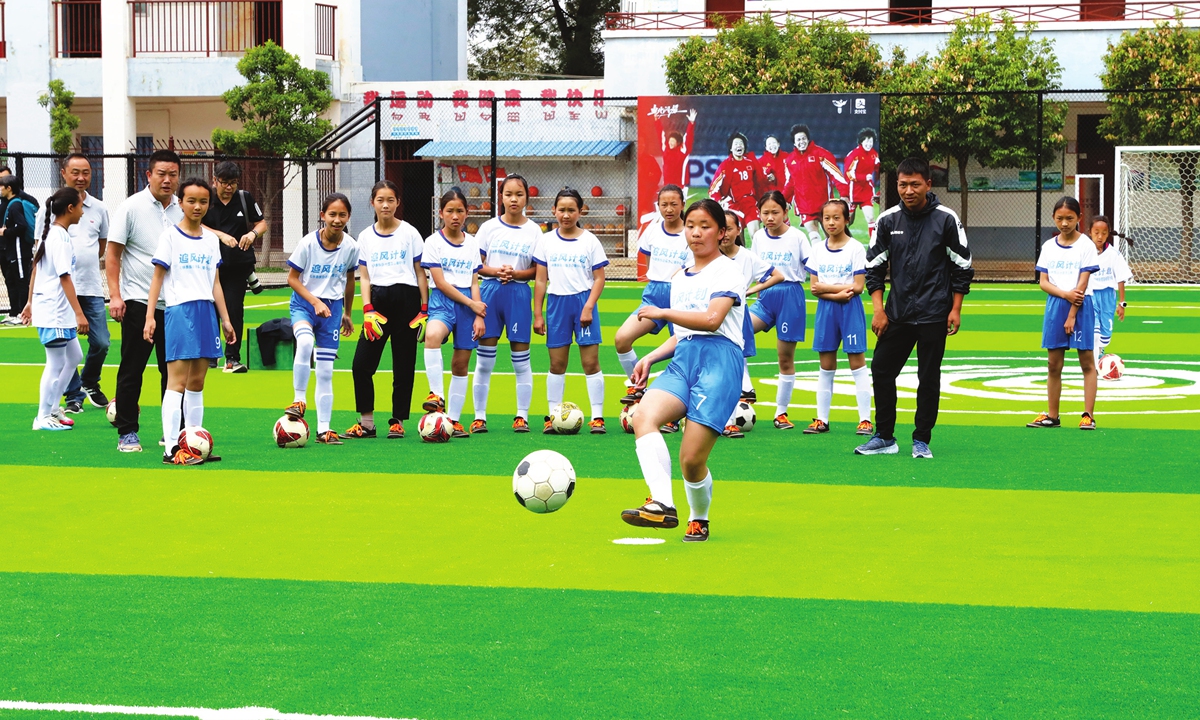 Female football players play on China's first women football-themed field that was opened in a Hope Primary School in Kunming, Southwest China's Yunnan Province, on Wednesday. Photo: cnsphotos