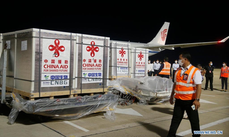 Workers transport Sinopharm COVID-19 vaccine at the Phnom Penh International Airport in Phnom Penh, Cambodia, April 28, 2021. A plane carrying the third batch of China-donated Sinopharm COVID-19 vaccine arrived in the capital of Cambodia Wednesday night.Photo:Xinhua
