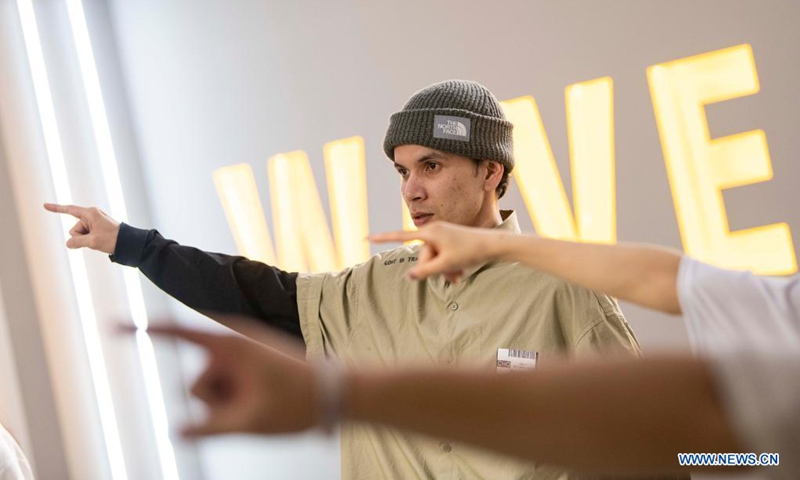 Xirli Abdukirm practices new dance moves with his colleagues at a street dance studio in Urumqi, northwest China's Xinjiang Uygur Autonomous Region, April 21, 2021.(Photo: Xinhua)