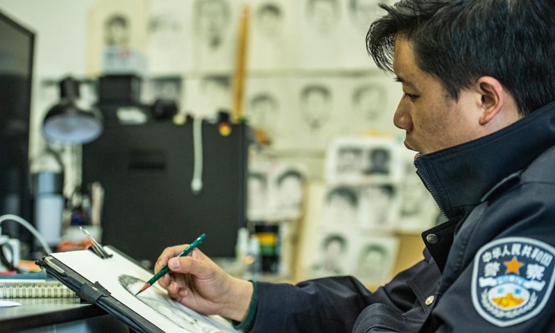 Zhu Yunhong profiles a possible suspect at large in his office at the criminal detective division of the Guiyang Public Security Bureau in Guiyang, southwest China's Guizhou Province, May 2, 2021.(Photo: Xinhua)