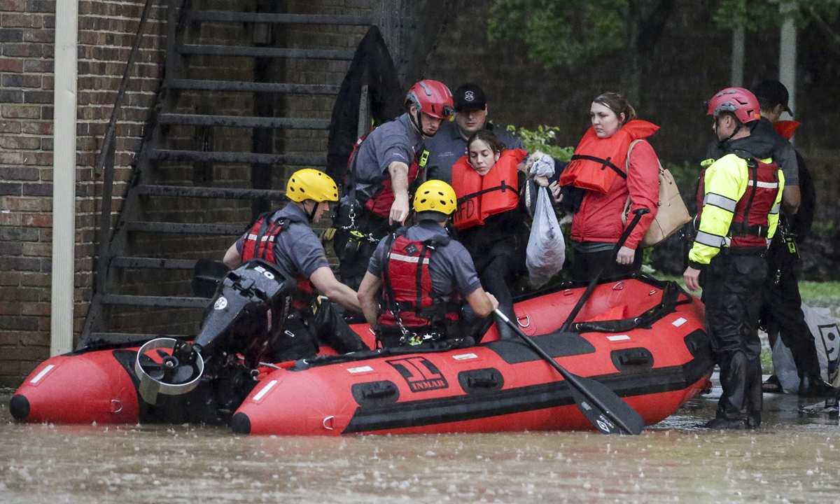 Residents of the Crescent at Lakeshore apartment complex are rescued by Homewood Fire and Rescue as severe weather produced torrential rainfall flooding several apartment buildings on Tuesday in Homewood, Alabama. Photo: VCG