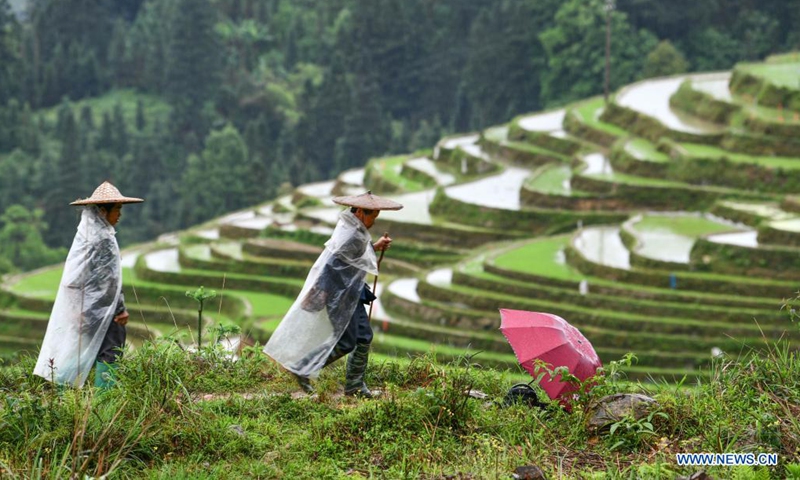 Farmers walk in the terraced fields in Dangniu Village of Congjiang County, southwest China's Guizhou Province, May 4, 2021.(Photo: Xinhua)