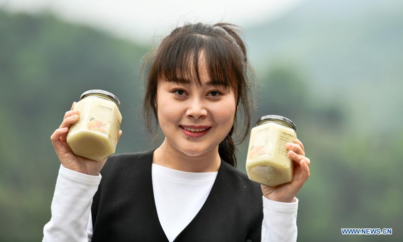 Yuan Xiaomei shows her honey products at her bee breeding base in Nayong County, southwest China's Guizhou Province, April 28, 2021. (Photo: Xinhua)