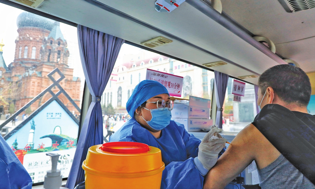 ?A man (right) receives a COVID-19 vaccine shot in a medical vehicle under the Saint Sophia Cathedral, a former Orthodox church and now a museum, in Harbin, capital of Northeast China's Heilongjiang on May 1. Photo: Li Hao/GT