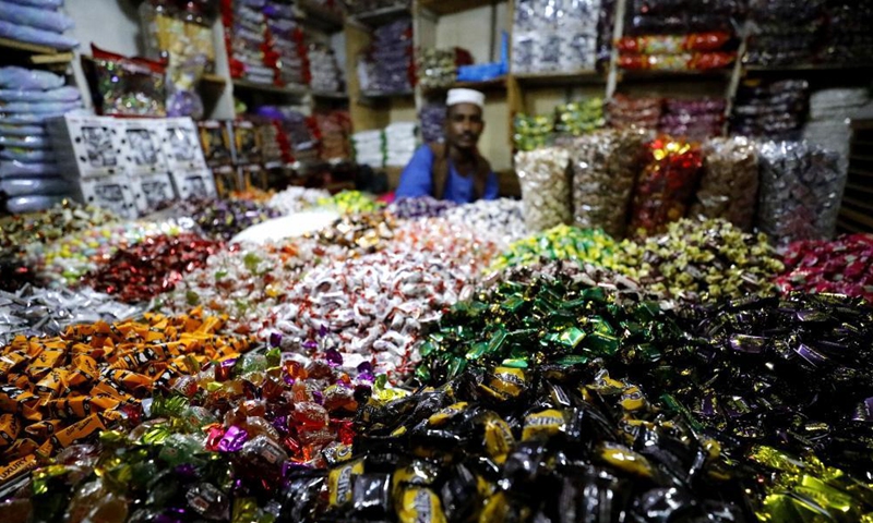 A vendor sells sweets at a market in Khartoum, Sudan, May 5, 2021. Eid Al-Fitr, also called the festival of breaking the fast that marks the end of the month-long dawn-to-sunset fasting of Ramadan, is celebrated by Muslims worldwide. Photo: Xinhua