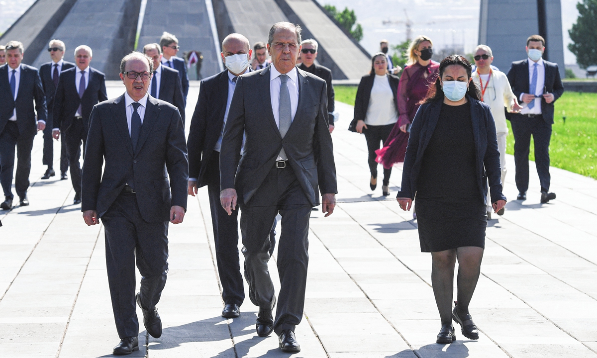 Russian Foreign Minister Sergei Lavrov (center) and Armenian Foreign Minister Ara Ayvazyan (left) attend Tsitsernakaberd, the Armenian Genocide memorial complex, in Yerevan, Armenia, on Thursday. Lavrov said on Thursday that Russia was considering supplying 1 million shots of the Sputnik V coronavirus vaccine to Armenia, the RIA news agency reported. Photo: AFP
