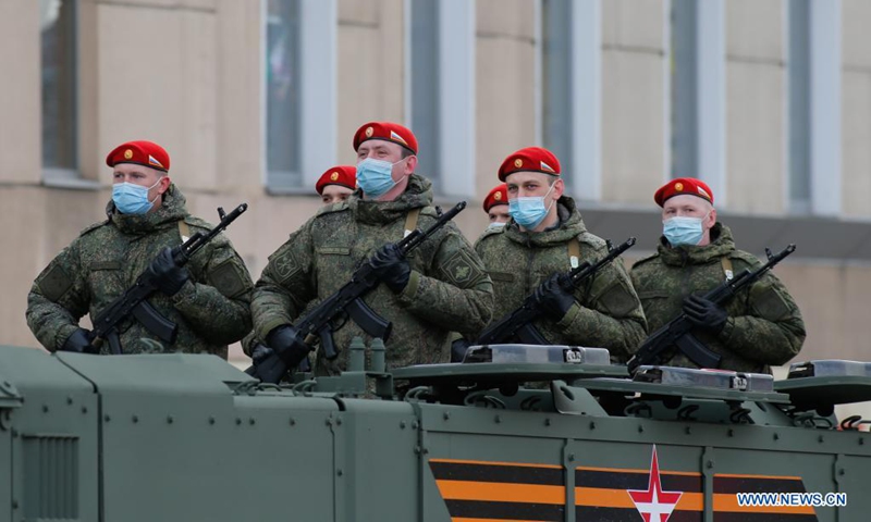 Soldiers are seen on a military vehicle before a rehearsal of the Victory Day parade in Moscow, Russia, on May 4, 2021. Russia holds Victory Day parades in various cities on May 9.(Photo: Xinhua)