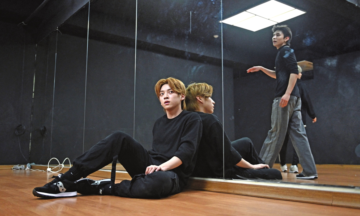 K-pop boy band Blitzers member Jang Jun-ho (left) takes a break during a dance practice session at a rehearsal studio in Seoul, South Korea, on April 29. Photo: AFP