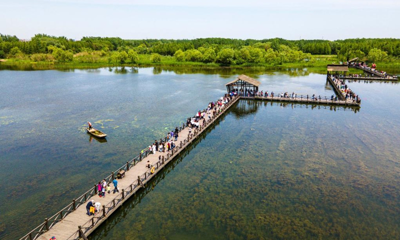 In this aerial photo, tourists visit Qinhu Lake national wetland park in Taizhou City, east China's Jiangsu Province, May 2, 2021. Official data showed 230 million domestic tourist trips were made during the five-day Labor Day holiday, up 119.7 percent from last year.(Photo: Xinhua)