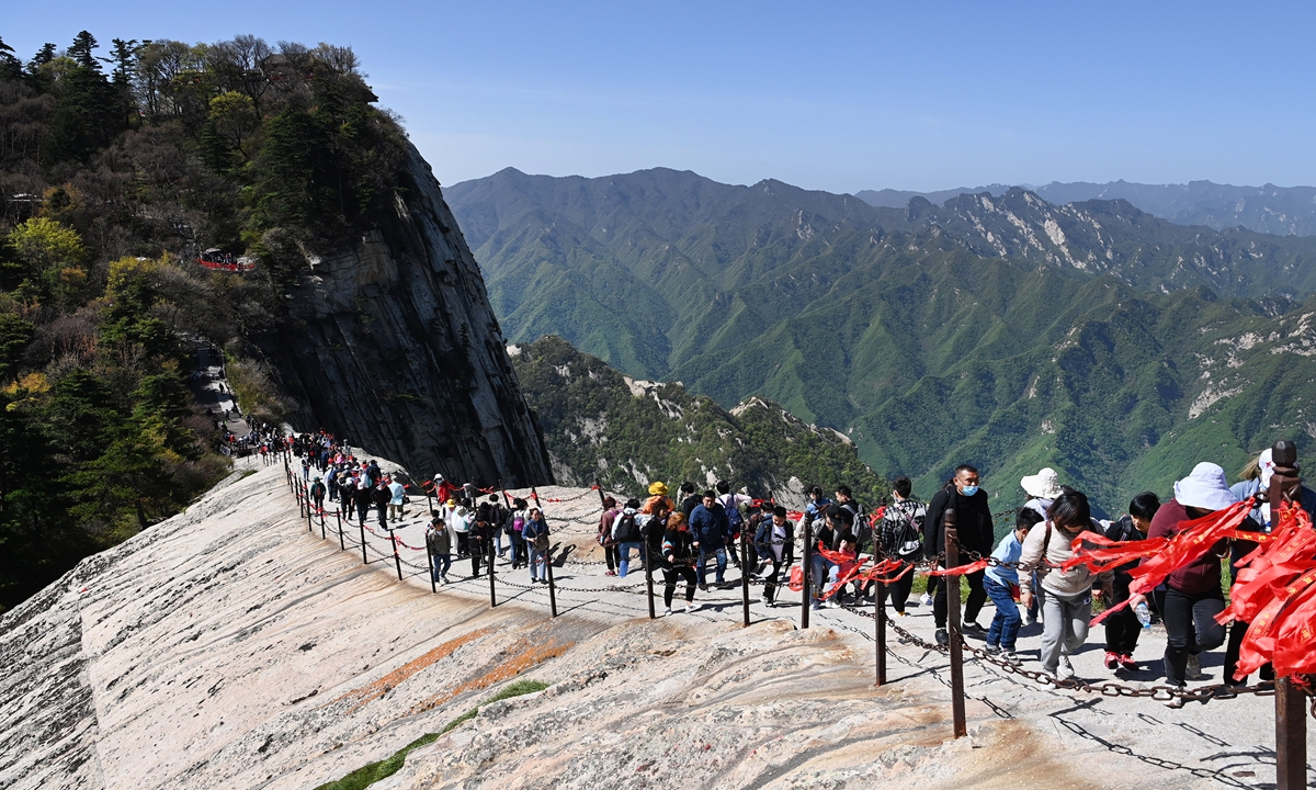 Tourists climb Huashan Mountain in Weinan, Northwest China's Shaanxi Province on Wednesday, the last day of the country's five-day May Day vacation. The tourist spot put a cap of 30,000 visits per day during the holiday due to coronavirus prevention precautions. Photo: Xinhua