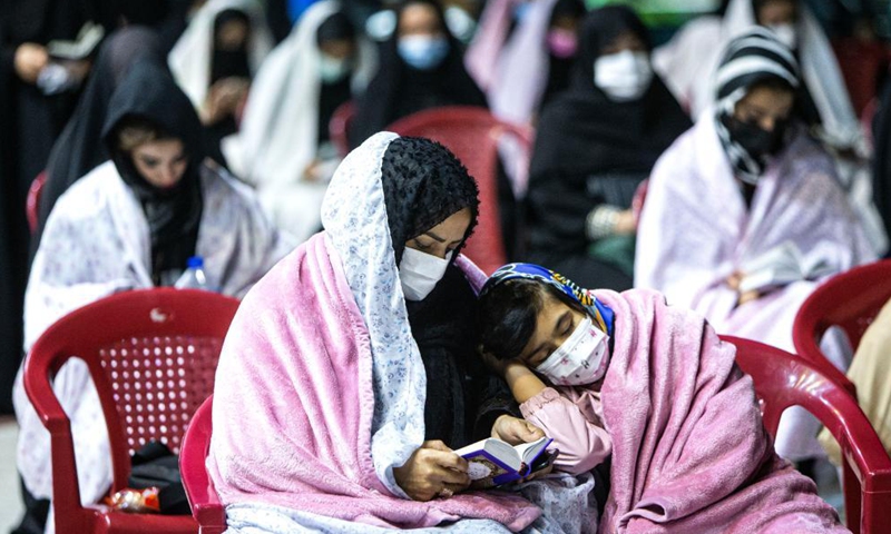 A woman and her daughter wearing face masks attend a Laylat al-Qadr night prayer during the holy fasting month of Ramadan in Emamzadeh Saleh mosque in Tehran, Iran, on May 6 , 2021.Photo:Xinhua