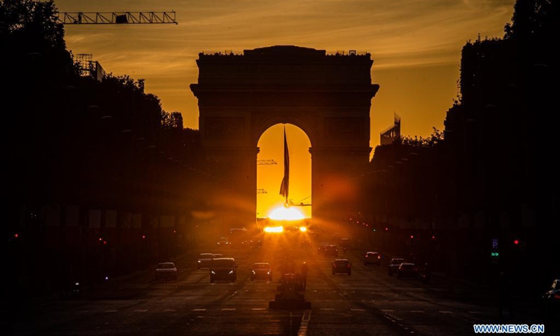Sunset through the Arc de Triomphe is seen at the Champs Elysees Avenue in Paris, France, on May 8, 2021.(Photo: Xinhua)