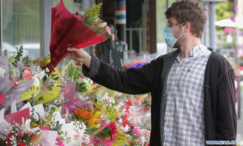 A man selects flowers at a flower shop ahead of Mother's Day in Burnaby, British Columbia, Canada, on May 8, 2021.(Photo: Xinhua)