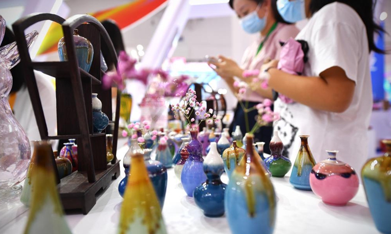 Photo taken on May 9, 2021 shows homemade color-glazed vases on display during the first China International Consumer Products Expo in Haikou, capital of south China's Hainan Province. Domestic exhibits with Chinese characteristics are quite a sight at the Expo, not only meeting the needs of consumers, but also reflecting the unique charm of Chinese culture. Photo: Xinhua