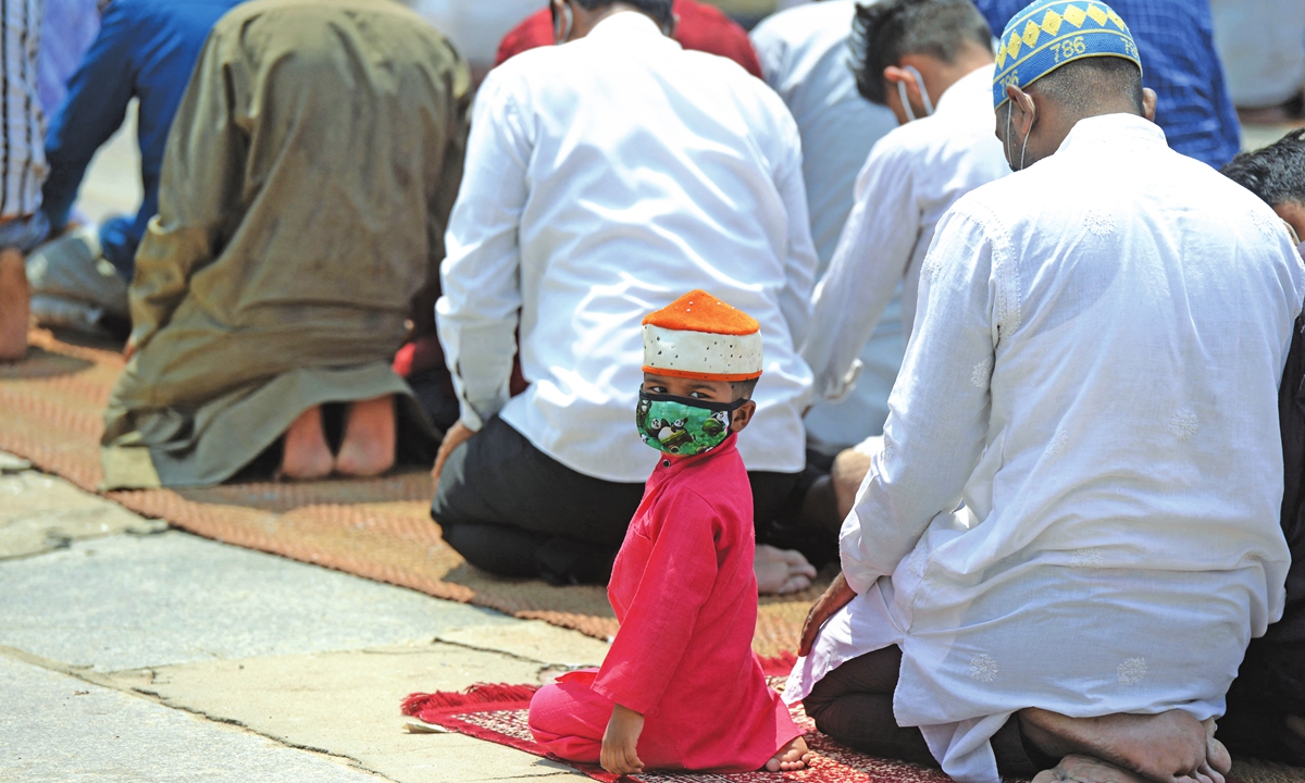 A boy looks back as Muslim devotees offer Jummat-Ul-Vida prayers on the last Friday of the holy month of Ramadan ahead of the Eid al-Fitr, at Mecca Masjid in Hyderabad, India, on Friday. Photo: AFP