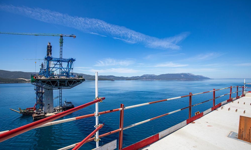 Photo taken on May 10, 2021 shows the construction site of the Peljesac Bridge near Komarna, Croatia. In January 2018, a Chinese consortium led by the China Road and Bridge Corporation (CRBC) won the bid for the first phase of the bridge and its access roads. Construction started six months later. The construction of the Peljesac Bridge will be completed in June 2022.  Photo: Xinhua