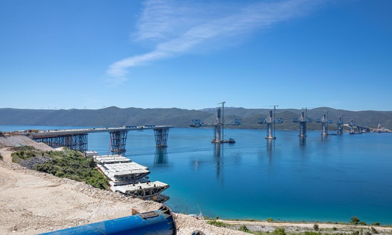 Photo taken on May 10, 2021 shows the construction site of the Peljesac Bridge near Komarna, Croatia. In January 2018, a Chinese consortium led by the China Road and Bridge Corporation (CRBC) won the bid for the first phase of the bridge and its access roads. Construction started six months later. The construction of the Peljesac Bridge will be completed in June 2022.  Photo: Xinhua