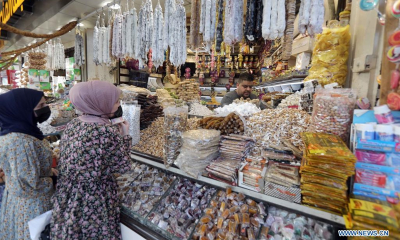 People buy dried fruits and sweets for the Eid al-Fitr in Baghdad, Iraq, on May 9, 2021. Eid al-Fitr marks the end of the Islamic holy month of Ramadan.(Photo: Xinhua)