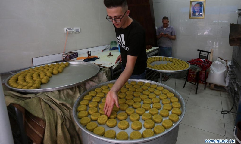 Vendors prepare traditional cookies at their shop ahead of the Eid al-Fitr festival in the West Bank city of Nablus, May 9, 2021. Eid Al-Fitr, also called the festival of breaking the fast, marks the end of the month-long fasting of Ramadan.(Photo: Xinhua)