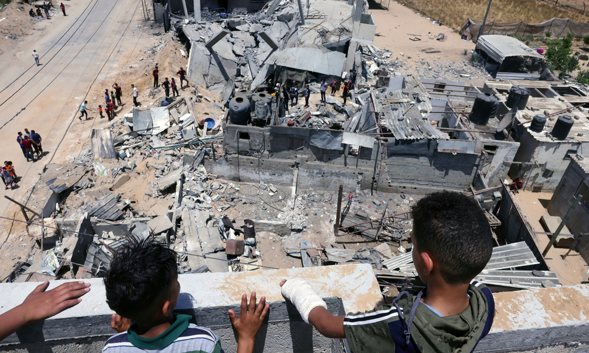 Palestinians inspect their house, after it was destroyed by an Israeli airstrike, in the city of Rafah, in the southern Gaza Strip on Sunday. Photo: AFP