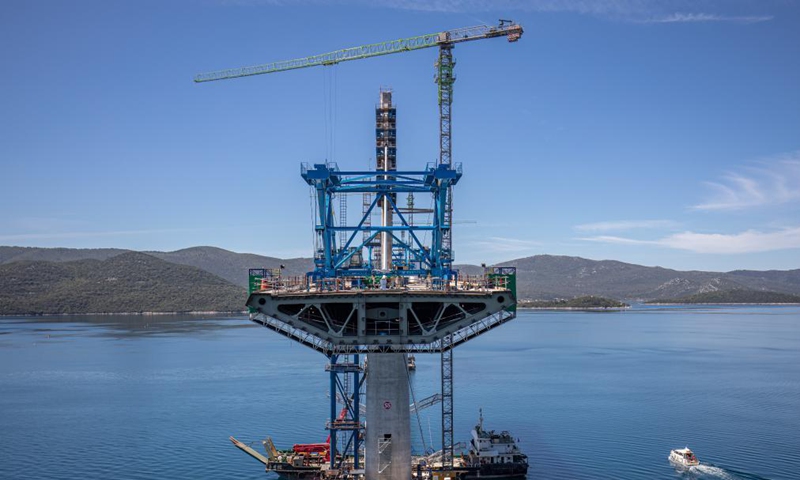 Photo taken on May 10, 2021 shows the construction site of the Peljesac Bridge near Komarna, Croatia. In January 2018, a Chinese consortium led by the China Road and Bridge Corporation (CRBC) won the bid for the first phase of the bridge and its access roads. Construction started six months later. The construction of the Peljesac Bridge will be completed in June 2022.  Photo: Xinhua