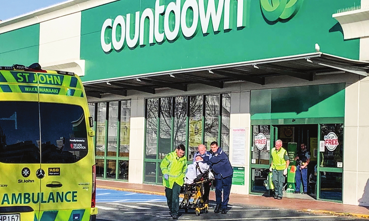 First responders take a victim to an ambulance outside a Countdown supermarket in central Dunedin, New Zealand, on Monday. A man began stabbing people at the supermarket on Monday, wounding five people, three of them critically, according to authorities. Photo: VCG